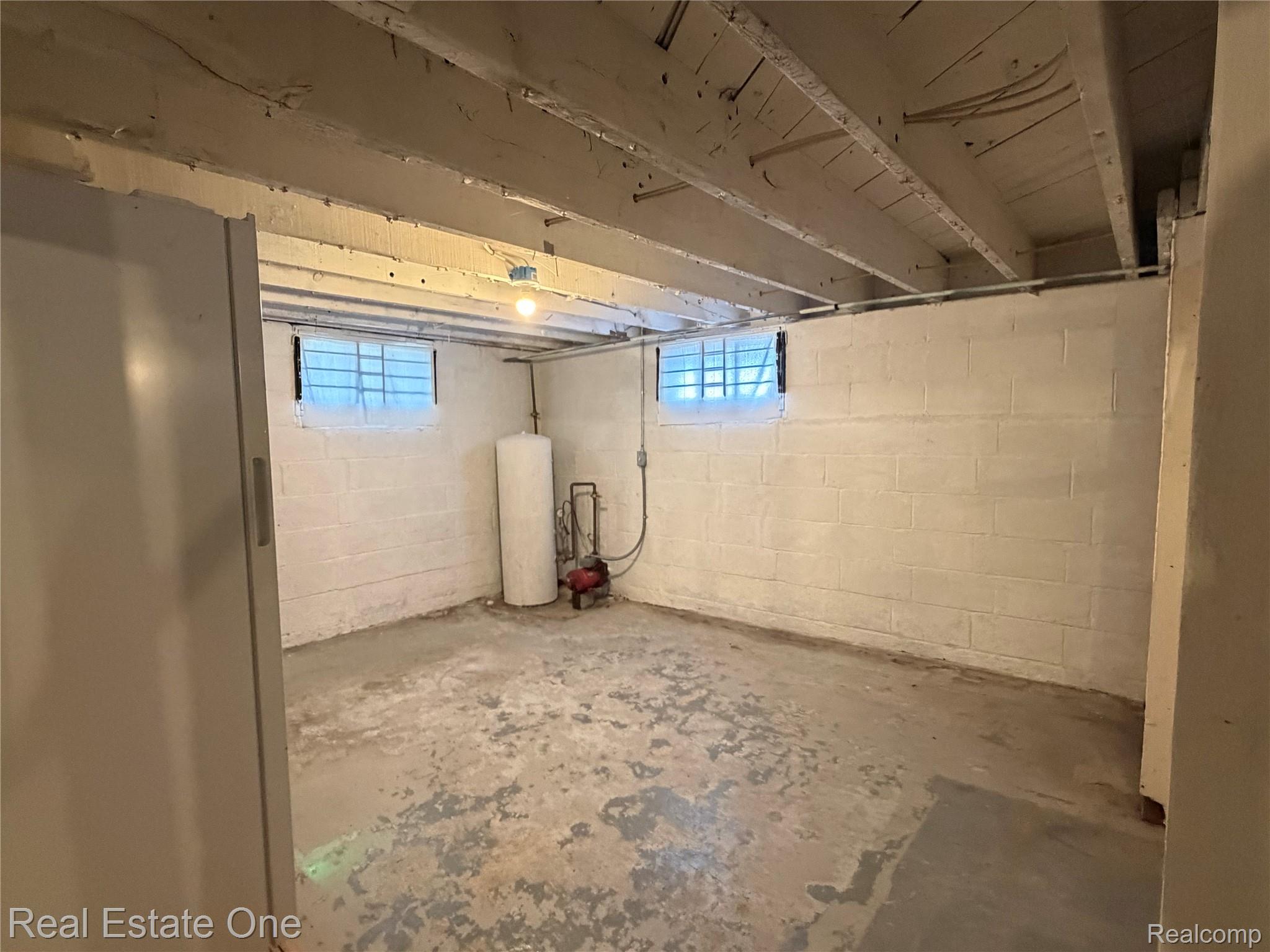 4985 Denton Road Canton, MI 48188 - Photo 31 of 37 Unfinished interior space with exposed ceiling joists, concrete flooring, and painted concrete block walls