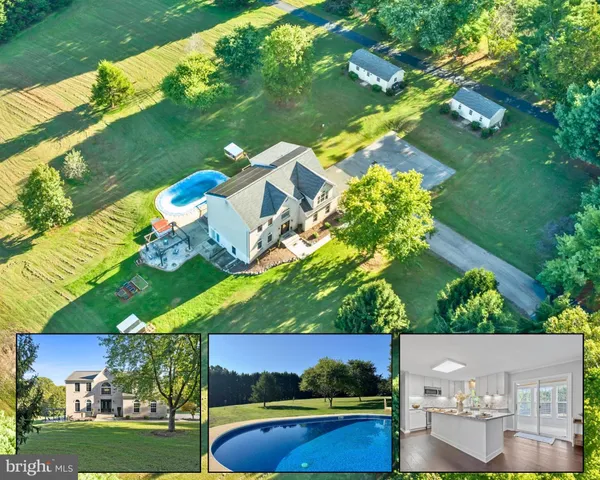 an aerial view of house with yard swimming pool and outdoor seating
