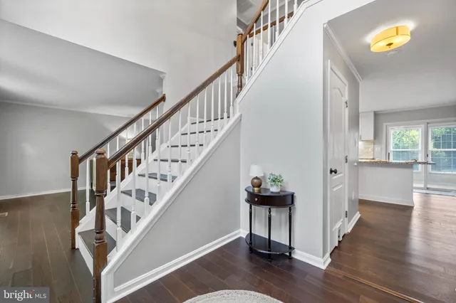 a large kitchen with stainless steel appliances lots of counter space and wooden floor