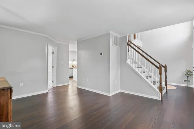 a kitchen with stainless steel appliances granite countertop a refrigerator a stove a sink dishwasher and a refrigerator with wooden floor