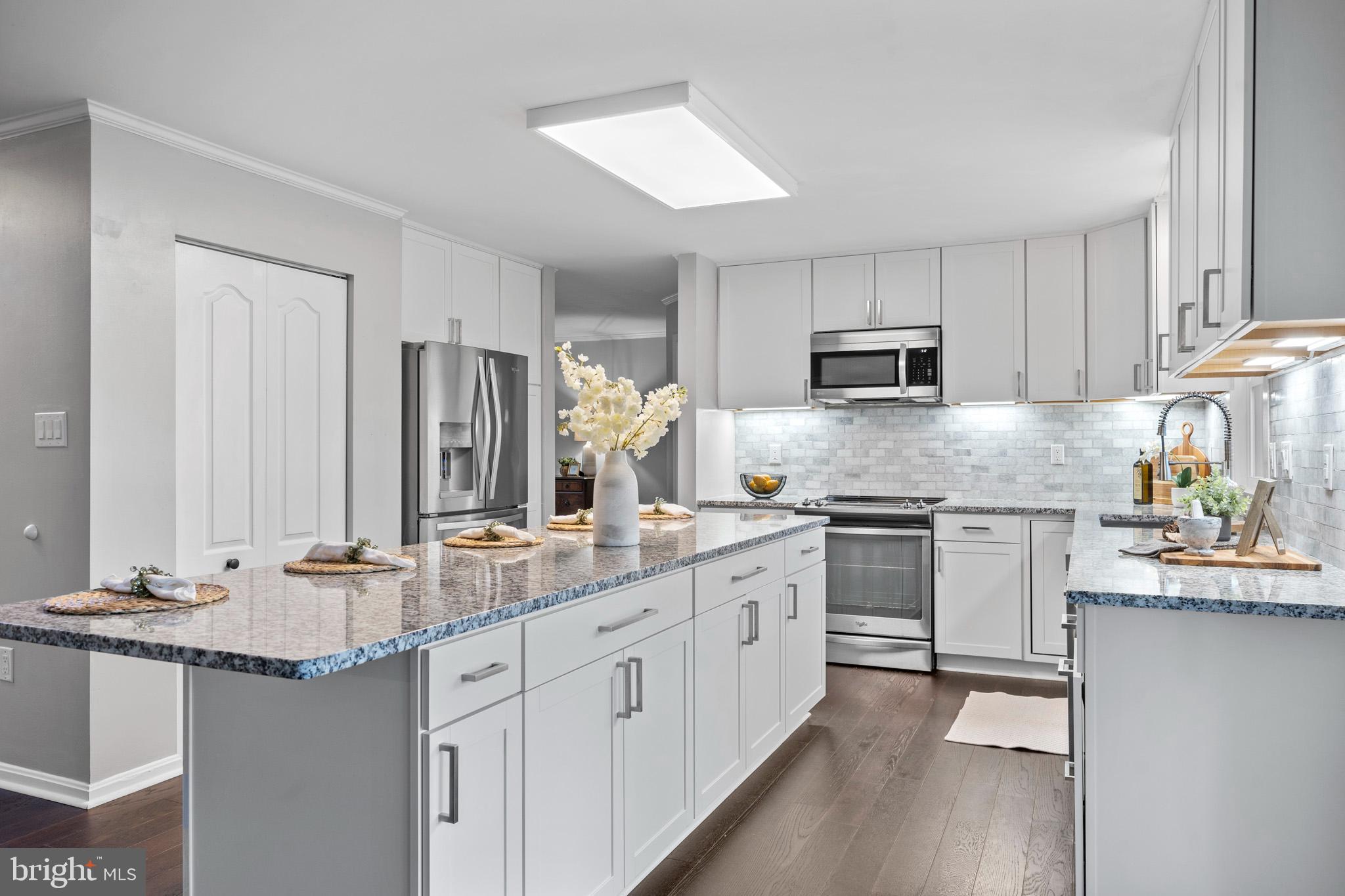3446 Chaneyville Road Owings, MD 20736 - Photo 23 of 74 a kitchen with kitchen island granite countertop a sink stove and cabinets