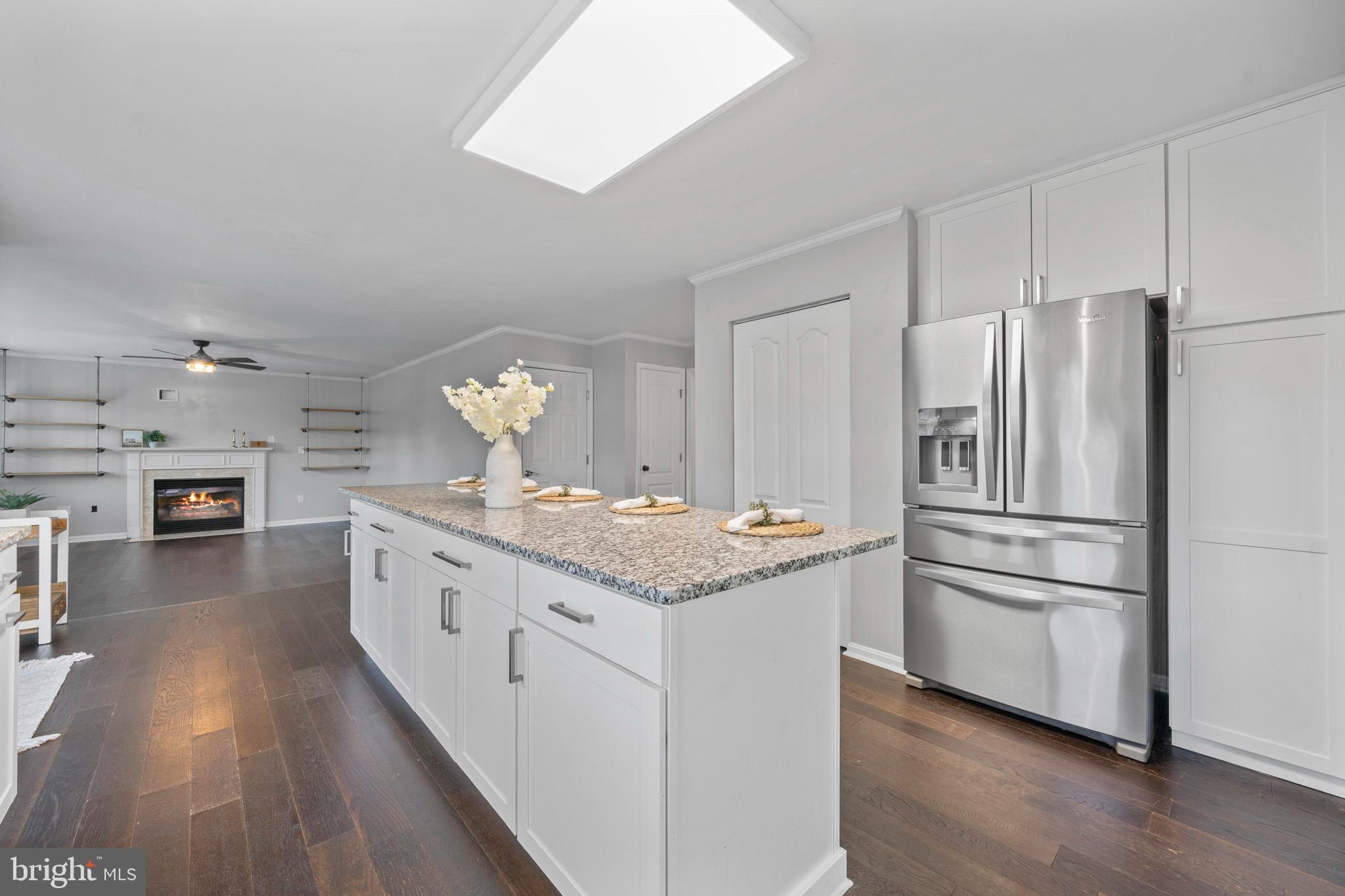 3446 Chaneyville Road Owings, MD 20736 - Photo 25 of 74 a kitchen with stainless steel appliances granite countertop a refrigerator a stove a sink dishwasher and a refrigerator with wooden floor