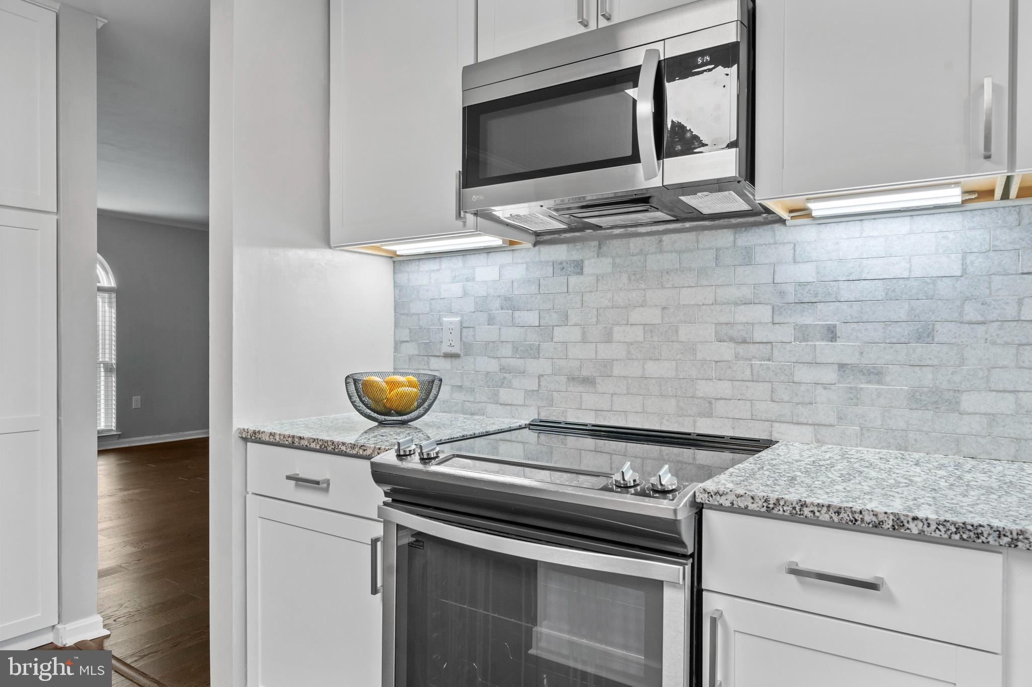3446 Chaneyville Road Owings, MD 20736 - Photo 26 of 74 a kitchen with a stove and a microwave