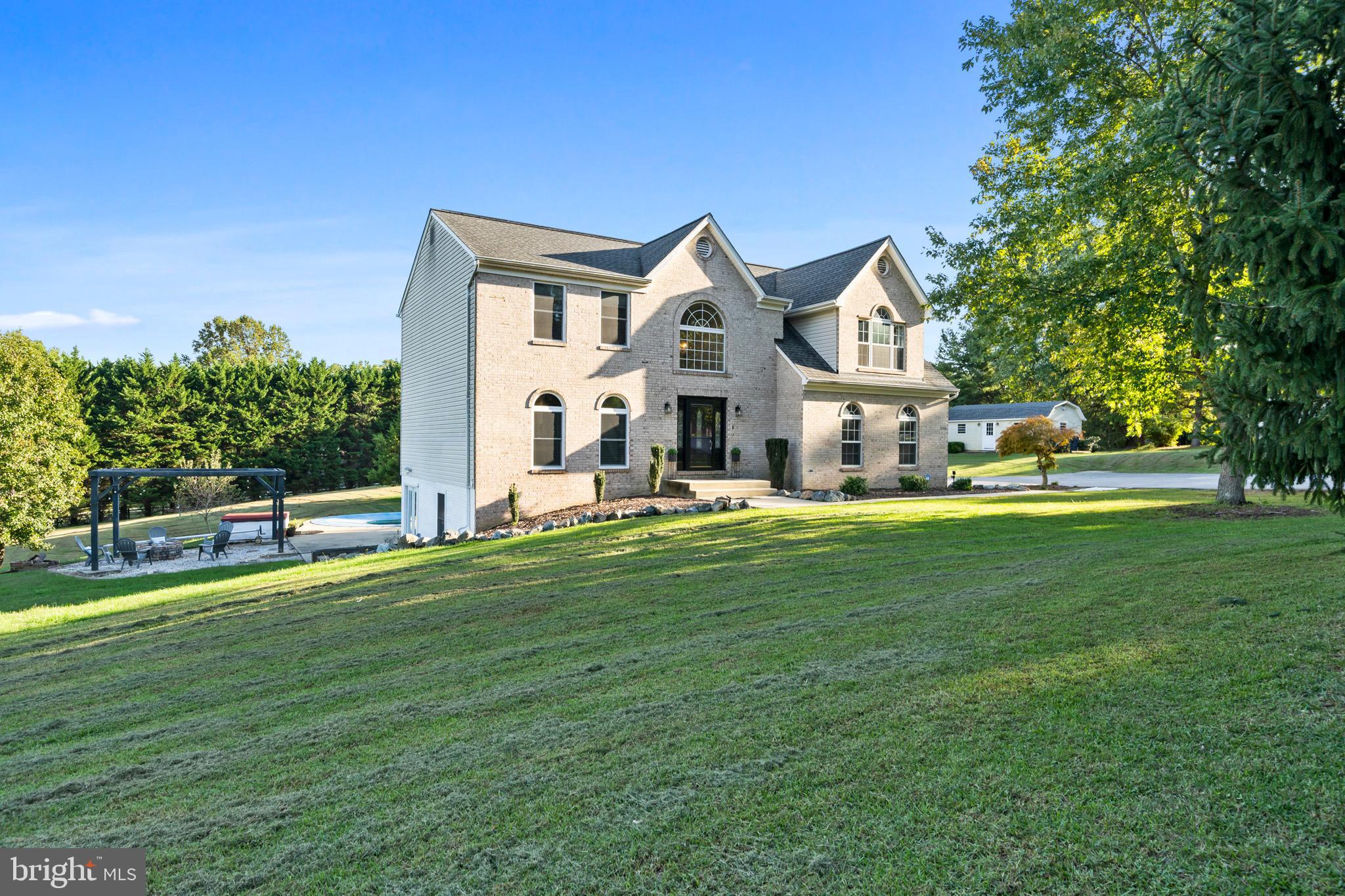 3446 Chaneyville Road Owings, MD 20736 - Photo 3 of 74 a front view of house with yard and trees in the background