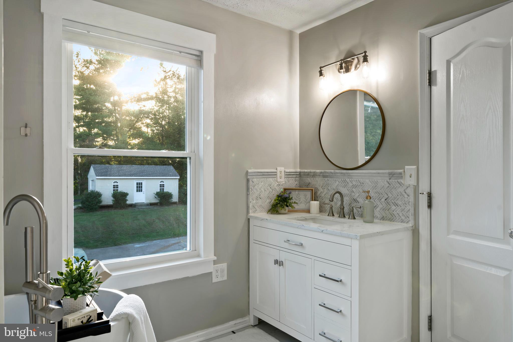 3446 Chaneyville Road Owings, MD 20736 - Photo 38 of 74 a bathroom with a double vanity sink and a mirror