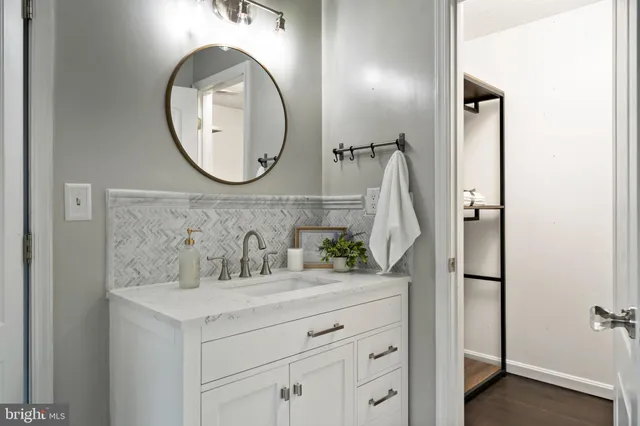 a bathroom with a shower curtain and a mirror