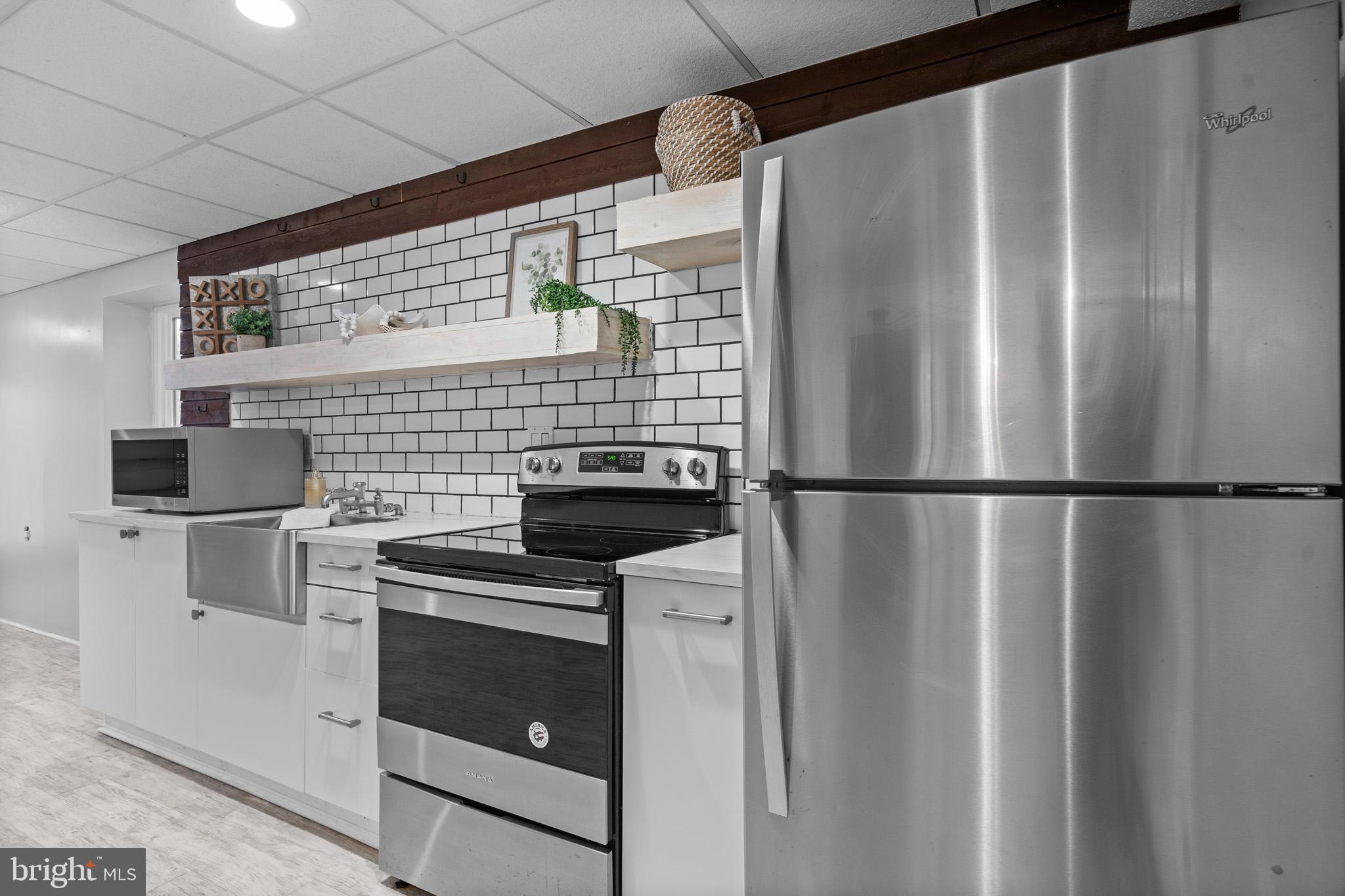 3446 Chaneyville Road Owings, MD 20736 - Photo 53 of 74 a kitchen with stainless steel appliances a refrigerator and a stove top oven