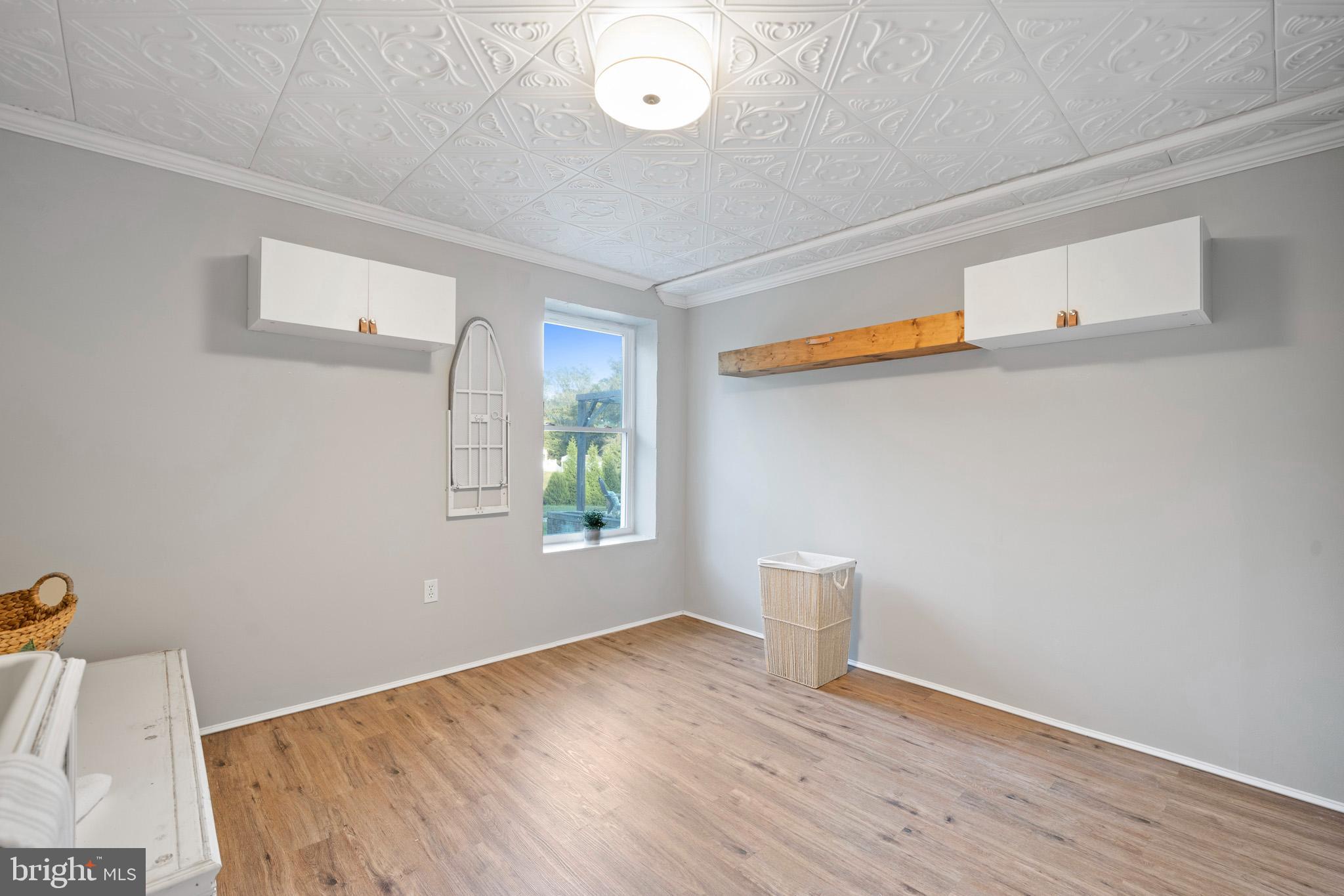 3446 Chaneyville Road Owings, MD 20736 - Photo 62 of 74 a view of an empty room with wooden floor and a window