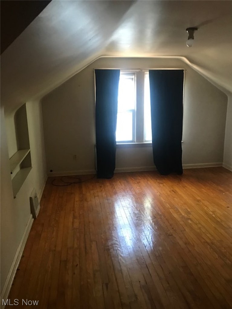 1697 Oakmount Road South Euclid, OH 44121 - Photo 7 of 10 Bonus room with lofted ceiling and dark hardwood flooring