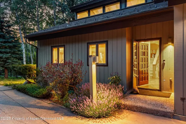 a bedroom with a large bed and a night stand