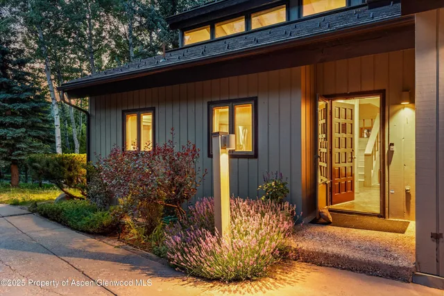 a bedroom with a large bed and a night stand