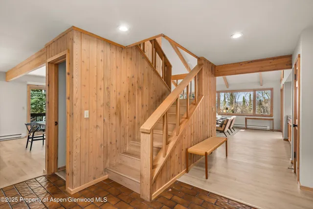 a spacious bedroom with a bed and a couch next to a window