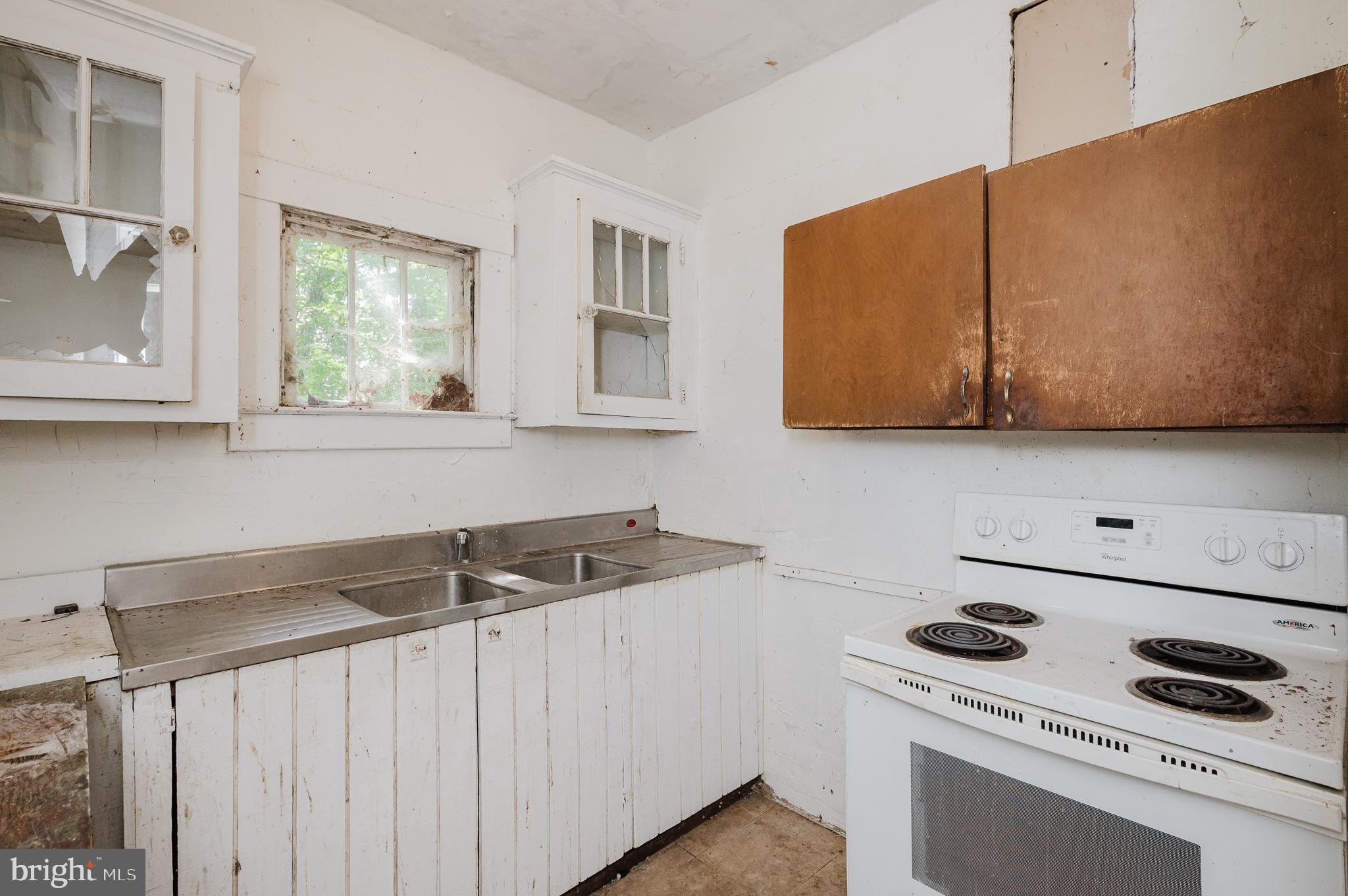 103 Sherwood Road Cockeysville, MD 21030 - Photo 13 of 59 a kitchen with a sink a stove and cabinets
