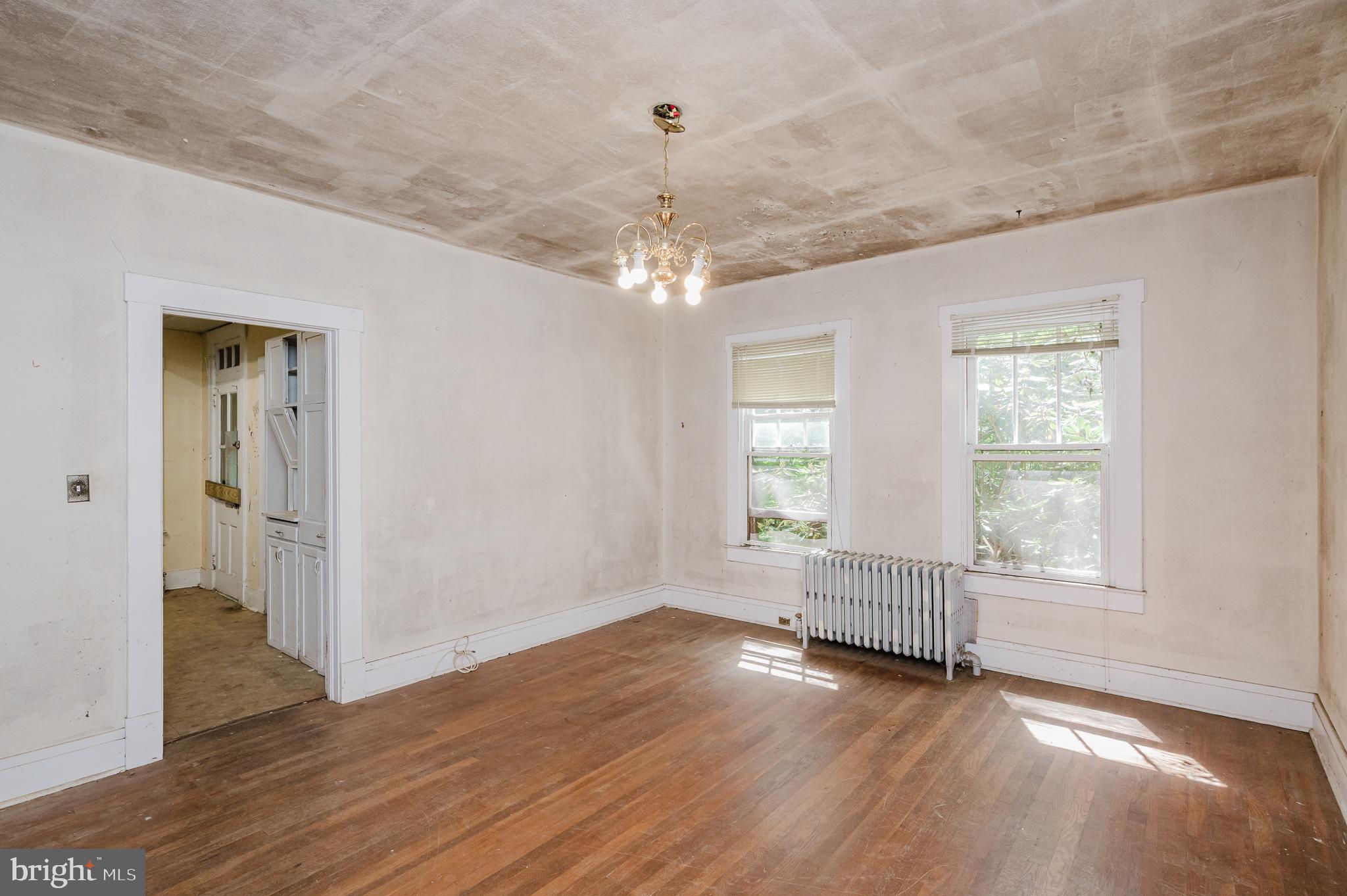 103 Sherwood Road Cockeysville, MD 21030 - Photo 2 of 59 an empty room with wooden floor cabinet and windows