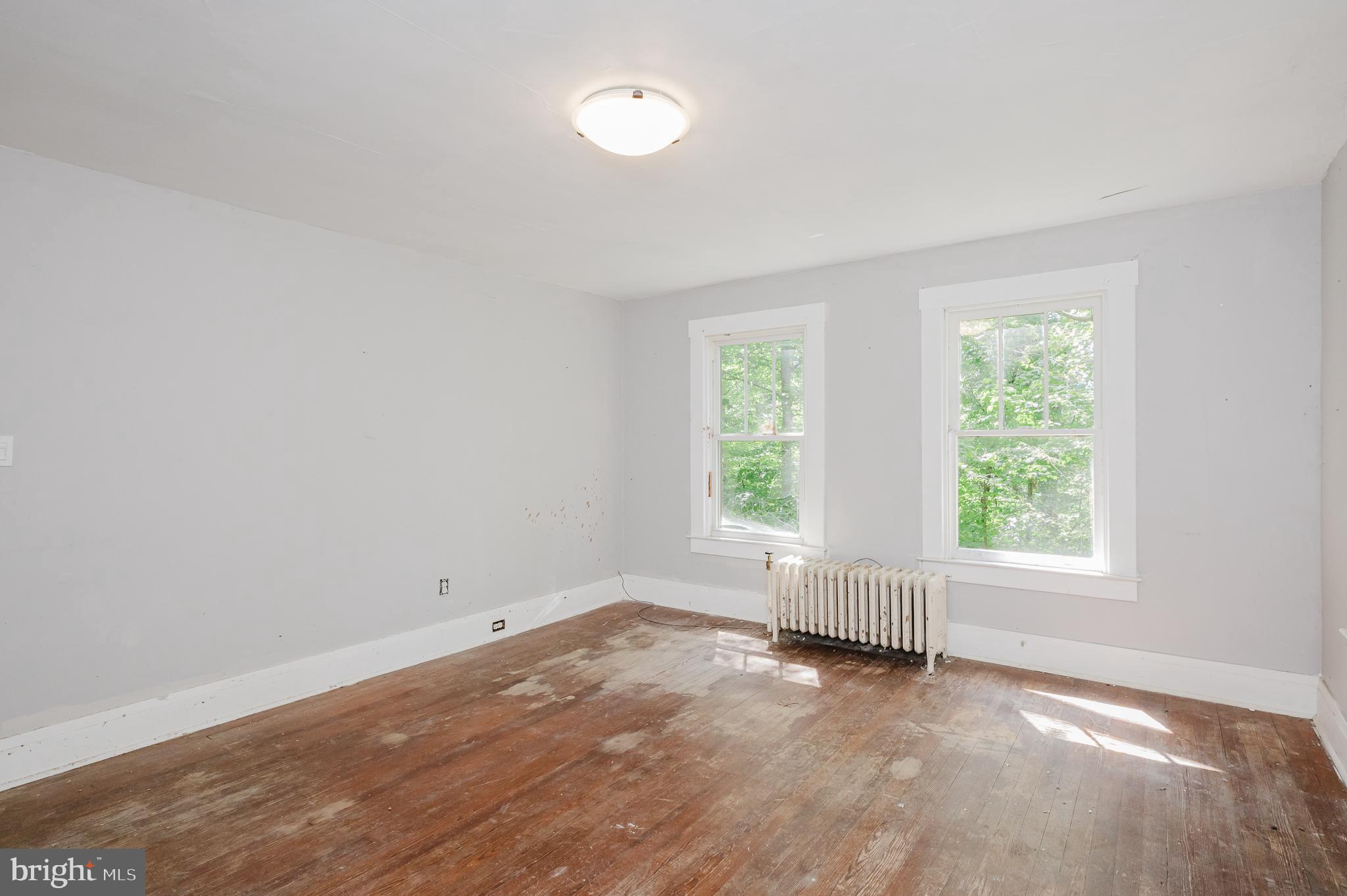 103 Sherwood Road Cockeysville, MD 21030 - Photo 28 of 59 an empty room with wooden floor and windows