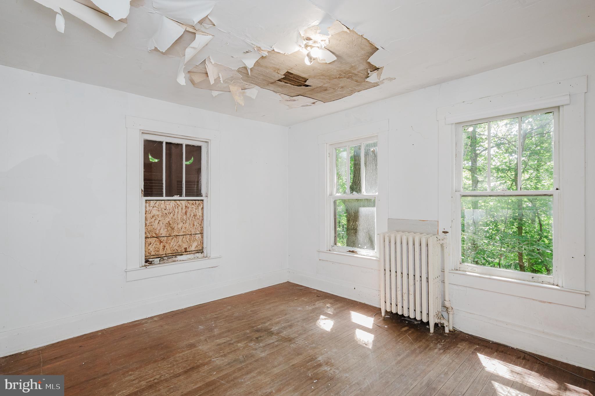 103 Sherwood Road Cockeysville, MD 21030 - Photo 32 of 59 a view of empty room with wooden floor and fan