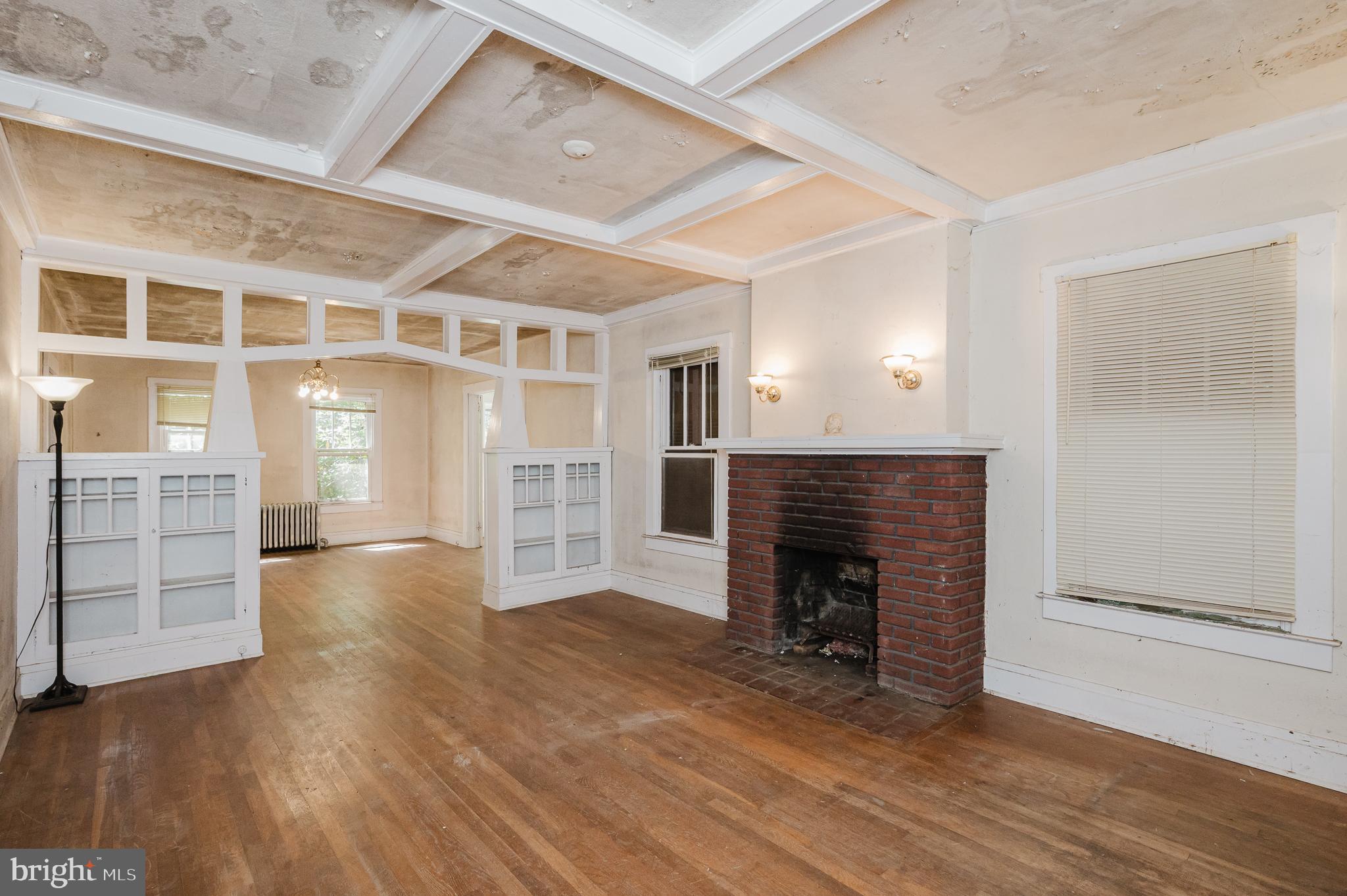 103 Sherwood Road Cockeysville, MD 21030 - Photo 6 of 59 an empty room with wooden floor fireplace and windows