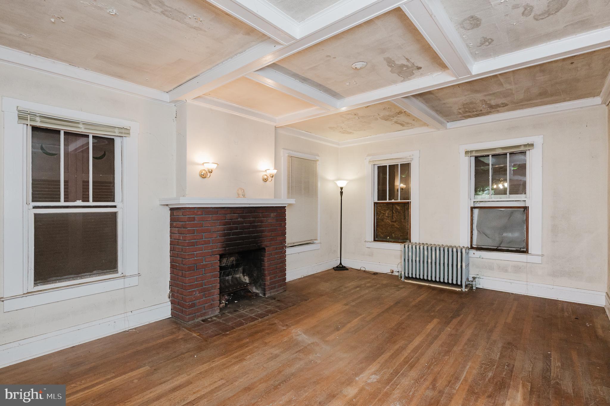 103 Sherwood Road Cockeysville, MD 21030 - Photo 9 of 59 an empty room with wooden floor and fireplace