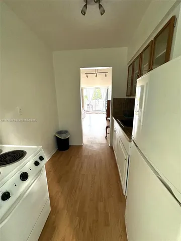 a view of kitchen with furniture and wooden floor