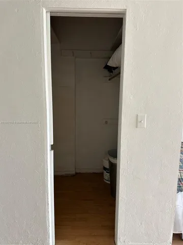 a kitchen with a sink and wooden floor