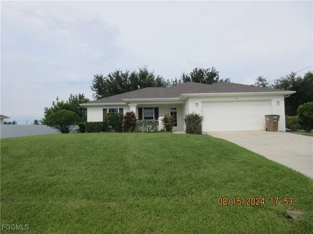 a front view of house with a garden