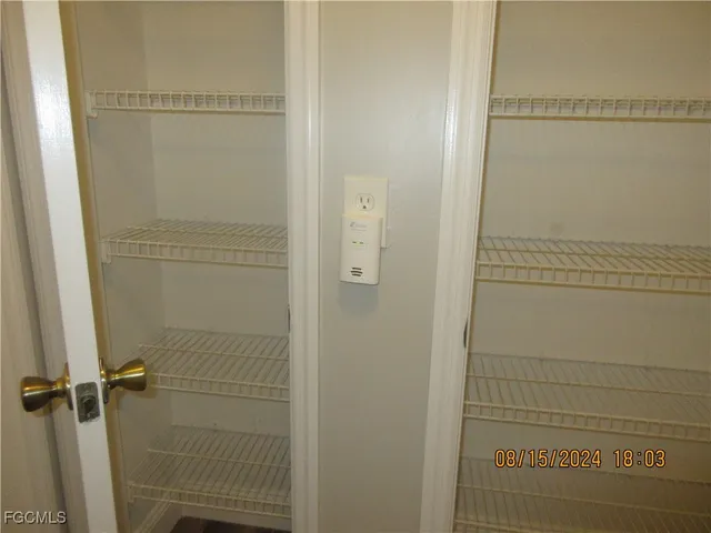 a kitchen with granite countertop a refrigerator a stove and a wooden floors