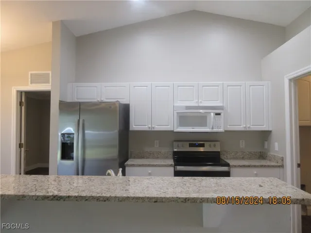 a kitchen with a sink a counter top space and a window