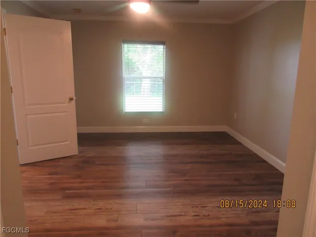 a white toilet sitting next to a white wall