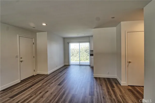 a view of a room with wooden floor and a window