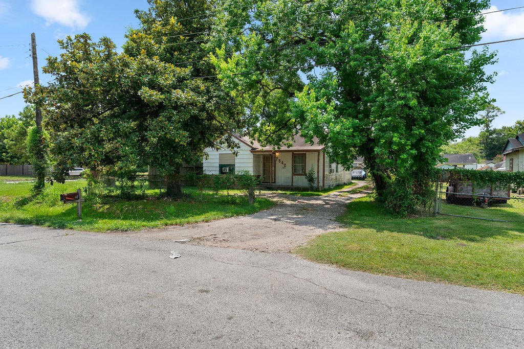 7842 Linda Vista Road Houston, TX 77028 - Photo 2 of 8 a view of a house with a yard and large trees
