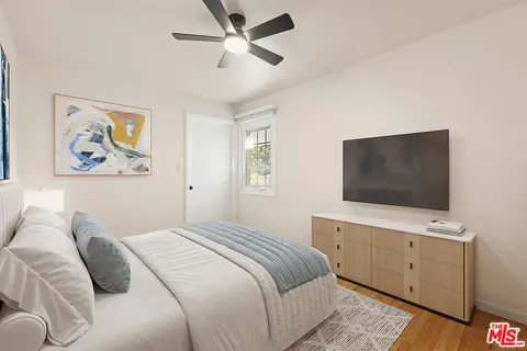 a bedroom with a large bed and a flat screen tv
