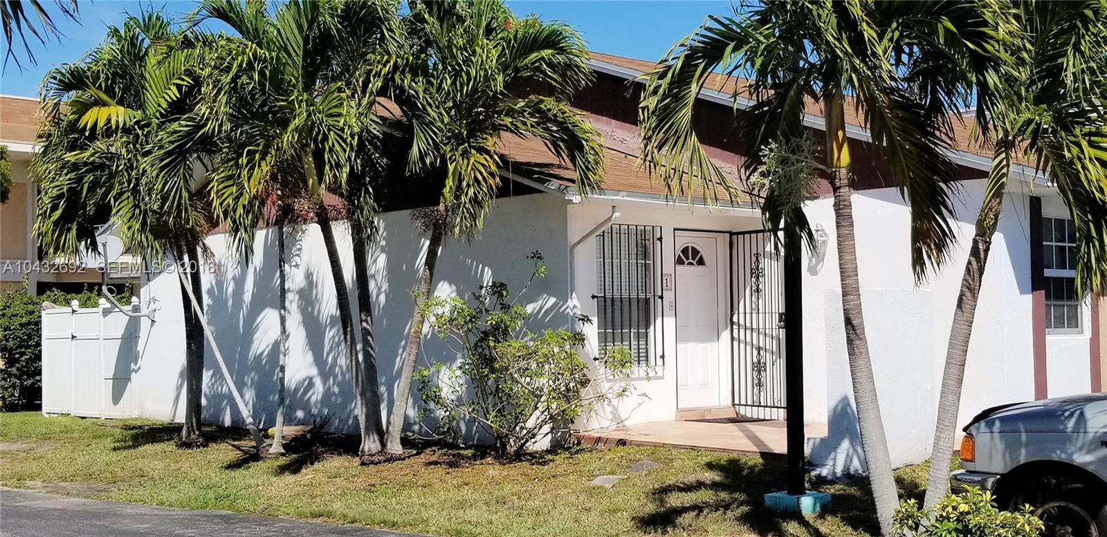 12193 Southwest 10th Street, Unit 1 Miami, FL 33184 - Photo 1 of 16 a front view of a house with a yard