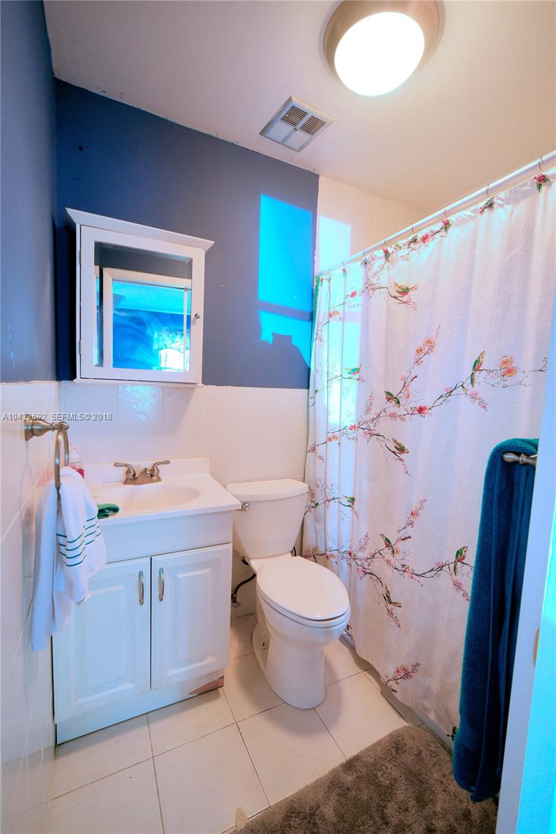 12193 Southwest 10th Street, Unit 1 Miami, FL 33184 - Photo 11 of 16 a bathroom with a sink toilet and shower