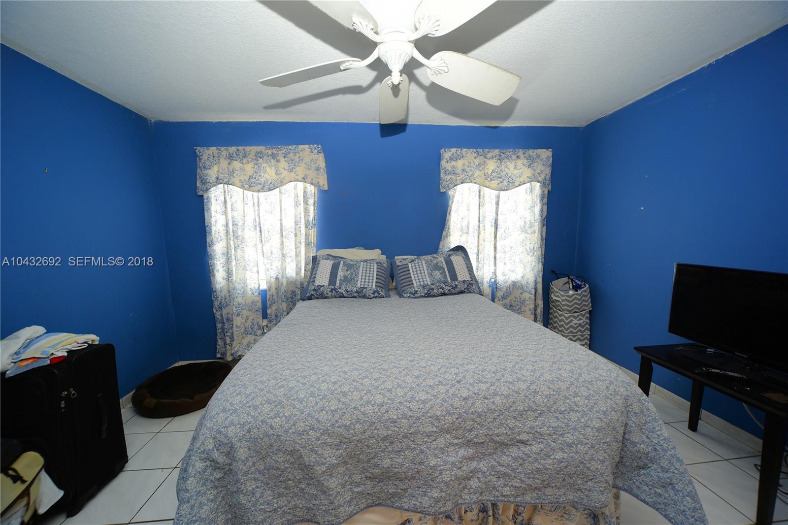12193 Southwest 10th Street, Unit 1 Miami, FL 33184 - Photo 12 of 16 a bedroom with bed and window