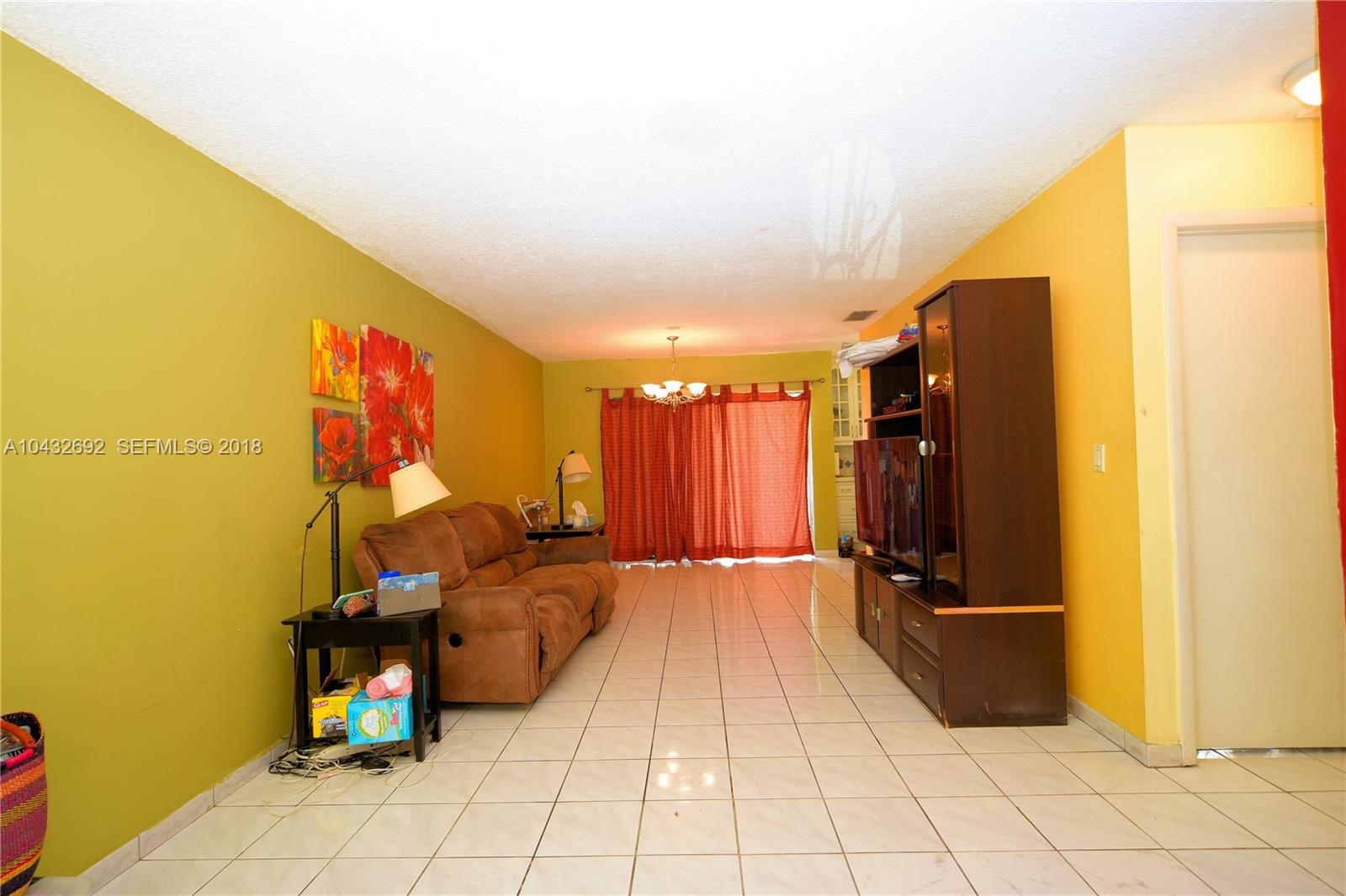 12193 Southwest 10th Street, Unit 1 Miami, FL 33184 - Photo 5 of 16 a bed room with a bed
