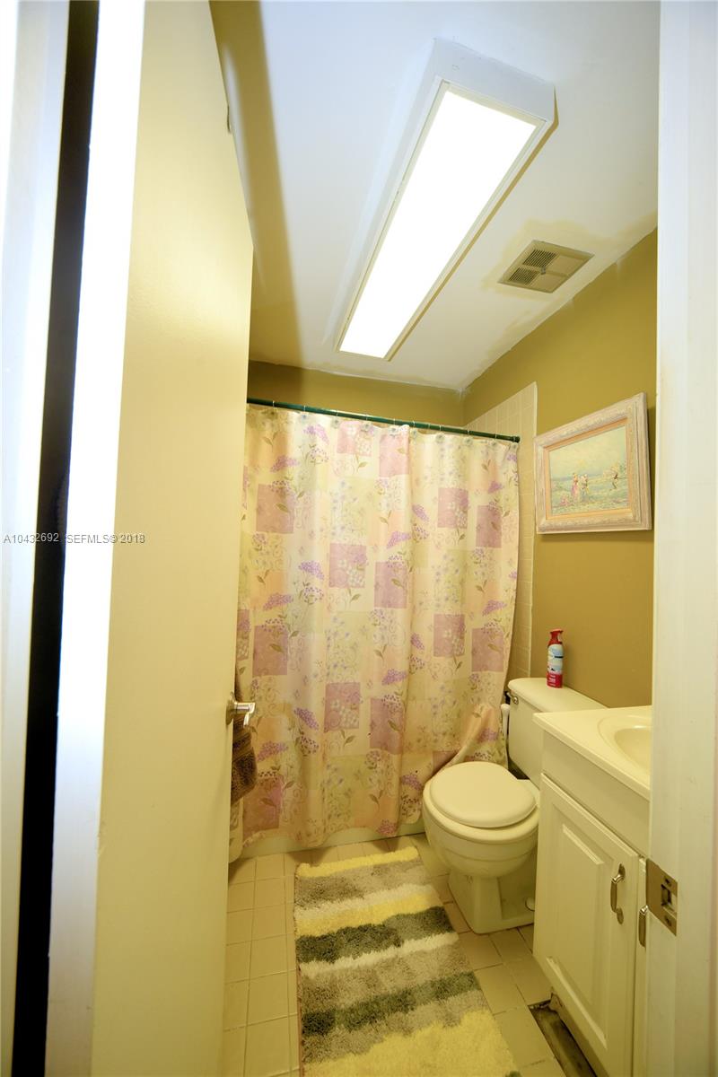 12193 Southwest 10th Street, Unit 1 Miami, FL 33184 - Photo 6 of 16 a bathroom with a toilet and a shower