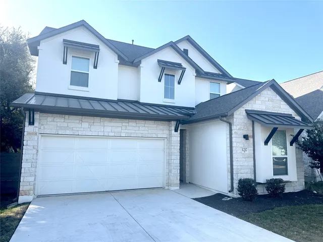 a front view of a house with white walls
