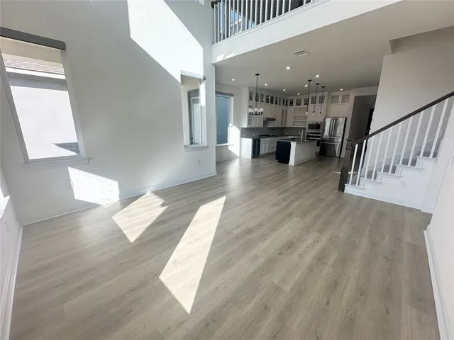 a view of kitchen and hall with wooden floor