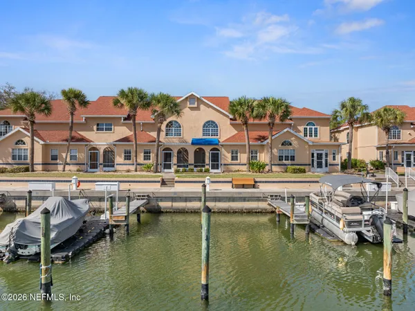 a view of houses with a swimming pool and outdoor seating