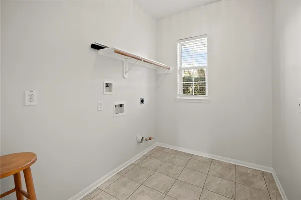 a view of a livingroom with wooden floor fireplace and a window