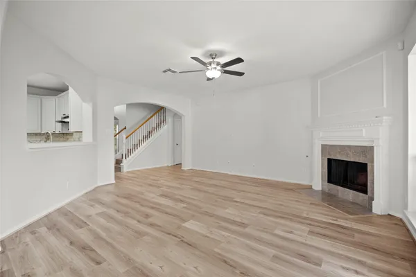 a view of an entryway with wooden floor and livingroom