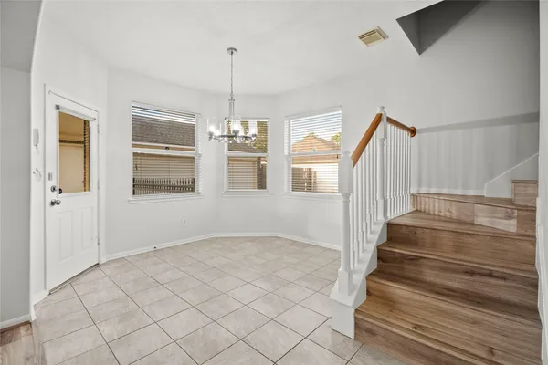 a kitchen with white cabinets sink and stainless steel appliances