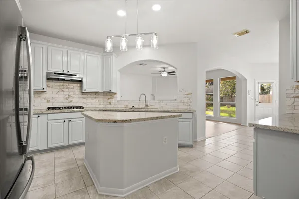 view of bathroom with granite countertop window and a granite counter tops