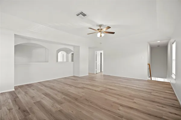 wooden floor in an empty room with a window