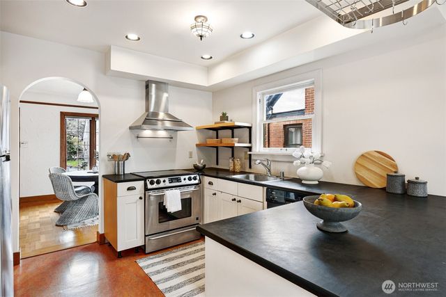 a kitchen with stainless steel appliances granite countertop a stove and a sink