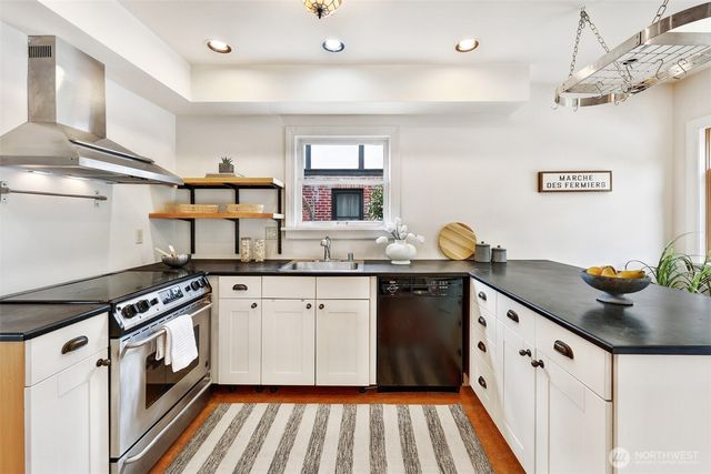 a kitchen with stainless steel appliances granite countertop a sink and cabinets