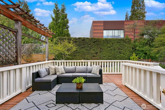 a balcony with wooden floor and outdoor seating