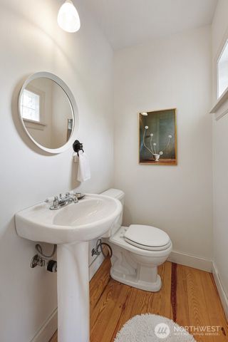a bathroom with a toilet a sink and a mirror