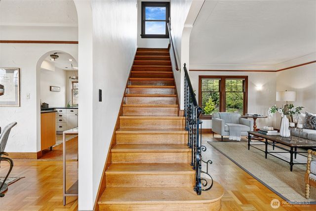 a view of entryway and hall with wooden floor