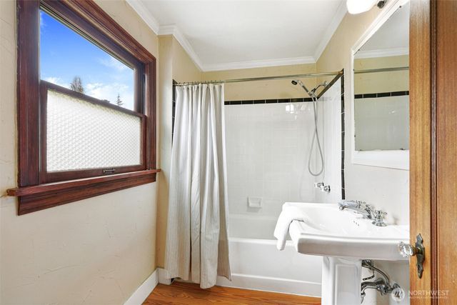 a bathroom with a sink mirror and a bathtub
